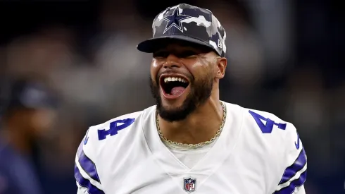 Quarterback Dak Prescott #4 of the Dallas Cowboys celebrates after safety Juanyeh Thomas #40 of the Dallas Cowboys intercepted a pass thrown by quarterback Jacob Eason #17 of the Seattle Seahawks in the fourth quarter of a NFL preseason football game at AT&T Stadium on August 26, 2022 in Arlington, Texas.