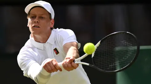 Jannik Sinner plays a backhand against Ben Shelton during the quarter-final match of Wimbledon 2025