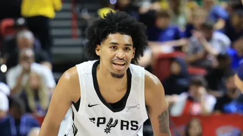 Dylan Harper #2 of the San Antonio Spurs smiles while guarding Ryan Nembhard #9 of the Dallas Mavericks in the first half of a 2025 NBA Summer League
