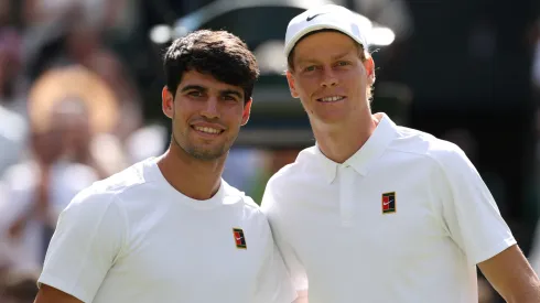 Carlos Alcaraz of Spain and Jannik Sinner of Italy pose for a photo at the net prior to the Wimbledon final.