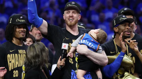 Isaiah Hartenstein #55 of the Oklahoma City Thunder celebrates with his son Elijah after defeating the Indiana Pacers 103-91 in Game Seven of the 2025 NBA Finals.
