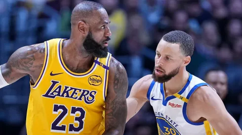 LeBron James #23 of the Los Angeles Lakers controls the ball against Stephen Curry #30 of the Golden State Warriors.