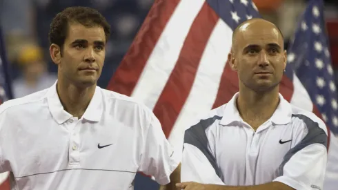 Pete Sampras and Andre Agassi stand as they receive their trophy during the 2002 US Open.