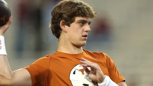 Arch Manning #16 of the Texas Longhorns warms up prior to a game against the Texas A&M Aggies at Kyle Field on November 30, 2024 in College Station, Texas.