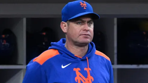 Manager Carlos Mendoza #64 of the New York Mets looks on from the dugout during the fourth inning against the San Diego Padres at Petco Park on July 29, 2025 in San Diego, California.