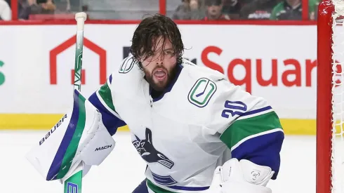 Spencer Martin #30 of the Vancouver Canucks tracks the puck after a shot knocks his mask off in the second period of the game against the Ottawa Senators at Canadian Tire Centre on November 08, 2022 in Ottawa, Ontario, Canada.