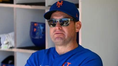 Carlos Mendoza #64 of the New York Mets looks on from the dugout before the game against the San Diego Padres at Petco Park on July 30, 2025 in San Diego, California.