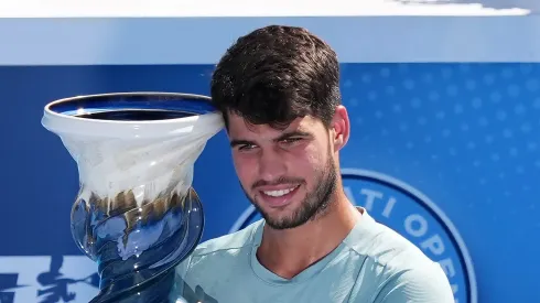 Carlos Alcaraz of Spain poses for photos with the Rookwood Cup after winning the men's singles title after Jannik Sinner of Italy retired during Day 12 of the Cincinnati Open