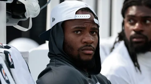 Micah Parsons #11 of the Dallas Cowboys sits on the sidelines.
