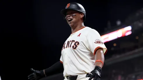 Rafael Devers #16 of the San Francisco Giants reacts after he hit a three-run home run.