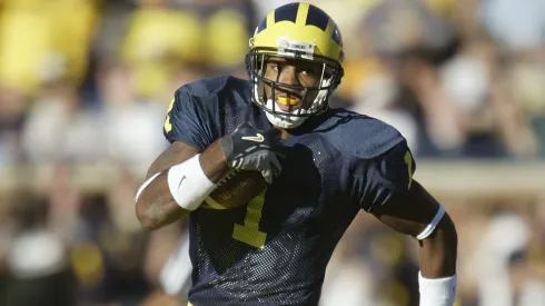 Braylon Edwards #1 of the Michigan Wolverines rushes after a reverse play against the Michigan State Spartans in 2004.