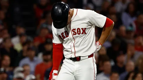 Roman Anthony #19 of the Boston Red Sox holds his lower back.