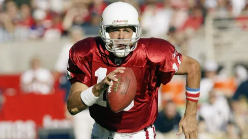 Quarterback Jake Plummer #16 of the Arizona Cardinals scrambles with the ball on a cornerback blitz during a game in 2002.