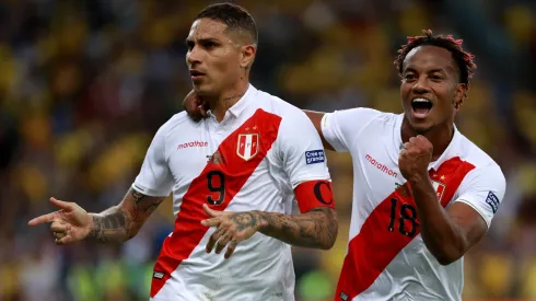 Paolo Guerrero of Peru celebrates a goal with teammate Andre Carrillo.