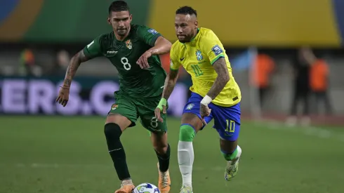 Neymar Jr. of Brazil competes for the ball with Diego Bejarano of Bolivia.