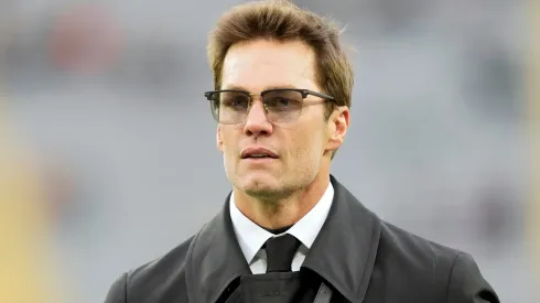 Tom Brady walks across the field.