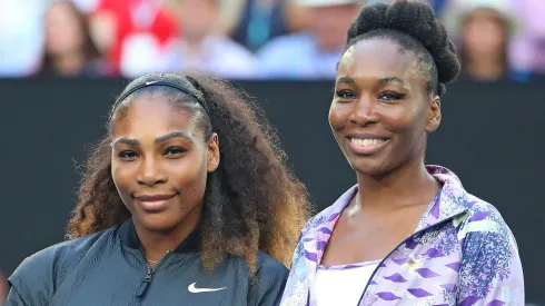 Venus Williams and Serena Williams pose for a photo prior to a game.