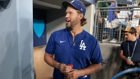Clayton Kershaw #22 of the Los Angeles Dodgers walks in the dugout.