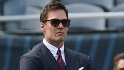 Tom Brady looks on from hte sidelines.