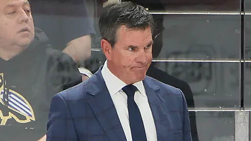 Mike Sullivan of the New York Rangers handles bench duties during the game in preseason action.