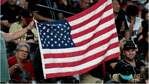 Fans hold up an American Flag