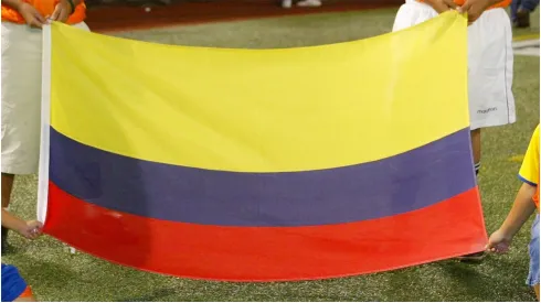 Children hold the flag of Colombia