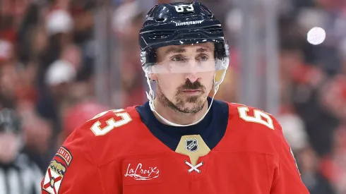 Brad Marchand skates on the ice during an NHL game, focused on the play ahead.