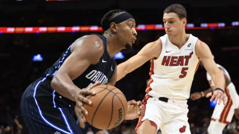 Wendell Carter Jr. #34 of the Orlando Magic controls the ball ahead of Nikola Jovic #5 of the Miami Heat.