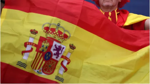 A fan of Spain holds up a flag
