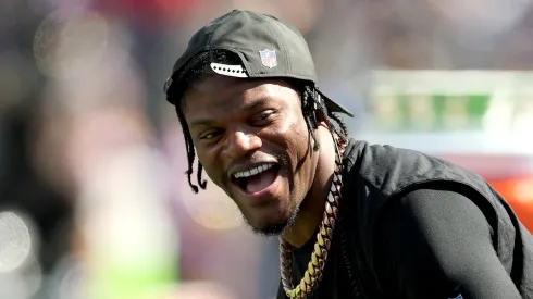 Quarterback Lamar Jackson #8 of the Baltimore Ravens laughs on the sidelines.