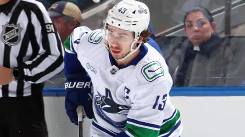 Quinn Hughes #43 of the Vancouver Canucks skates in an NHL game.