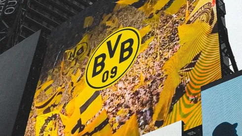 A screen in Times Square displays the Borussia Dortmund crest.