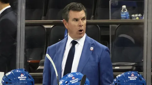 Head coach Mike Sullivan of the New York Rangers tends to the bench during the game.