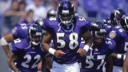 Peter Boulware #58 of the Baltimore Ravens jogs out onto the field during a game in 2000.