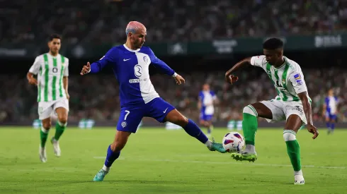 SEVILLE, SPAIN – AUGUST 20: Antoine Griezmann of Atletico Madrid and Abner of Real Betis battle for the ball during the LaLiga EA Sports match between Real Betis and Atletico Madrid at Estadio Benito Villamarin on August 20, 2023 in Seville, Spain. (Photo by Fran Santiago/Getty Images)
