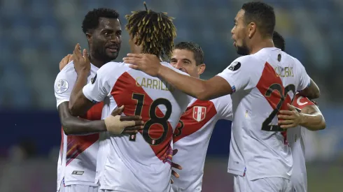 GOIANIA, BRAZIL – JUNE 20: Christian Ramos, André Carrillo and Alexander Callens of Peru celebrate with teammates after their second goal scored by an own goal of Yerry Mina of Colombia (not in frame) during a group B match between Colombia and Peru as part of Copa America Brazil 2021 at Estadio Olimpico on June 20, 2021 in Goiania, Brazil. (Photo by Pedro Vilela/Getty Images)
