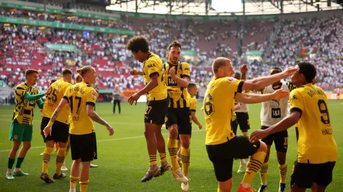 AUGSBURG, GERMANY – MAY 21: Karim Adeyemi and Mats Hummels of Borussia Dortmund celebrate after the team's victory in the Bundesliga match between FC Augsburg and Borussia Dortmund at WWK-Arena on May 21, 2023 in Augsburg, Germany. (Photo by Adam Pretty/Getty Images)