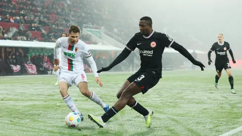 AUGSBURG, GERMANY – DECEMBER 03: William Pacho of Eintracht Frankfurt shoots under pressure from Elvis Rexhbecaj of FC Augsburg  during the Bundesliga match between FC Augsburg and Eintracht Frankfurt at WWK-Arena on December 03, 2023 in Augsburg, Germany. (Photo by Alexander Hassenstein/Getty Images)
