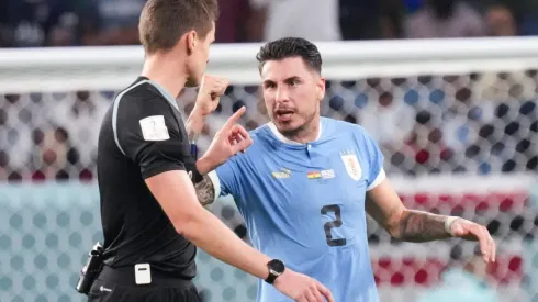 (221202) &#8212; AL WAKRAH, Dec. 2, 2022 &#8212; Jose Maria Gimenez (R) of Uruguay argues with referee Daniel Siebert after the Gr
