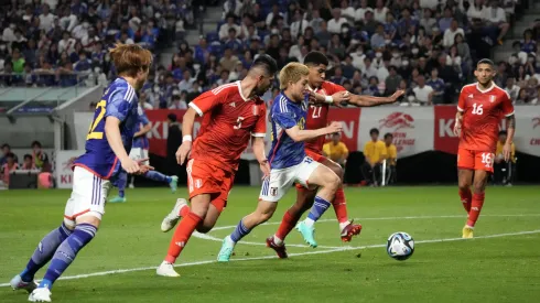 SUITA, JAPAN – JUNE 20: Ritsu Doan of Japan competes for the ball against Wilder Cartagena and Carlos Zambrano of Peru during the international friendly match between Japan and Peru at Panasonic Stadium Suita on June 20, 2023 in Suita, Osaka, Japan. (Photo by Koji Watanabe/Getty Images)