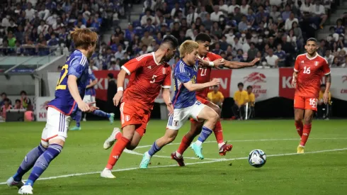 SUITA, JAPAN – JUNE 20: Ritsu Doan of Japan competes for the ball against Wilder Cartagena and Carlos Zambrano of Peru during the international friendly match between Japan and Peru at Panasonic Stadium Suita on June 20, 2023 in Suita, Osaka, Japan. (Photo by Koji Watanabe/Getty Images)
