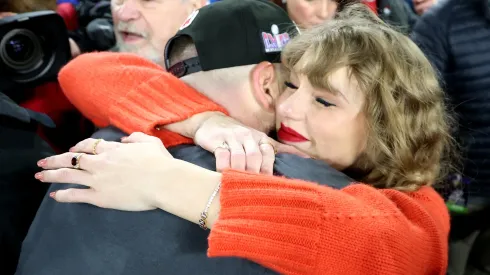 Travis Kelce #87 of the Kansas City Chiefs celebrates with Taylor Swift after a 17-10 victory against the Baltimore Ravens.
