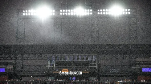 DENVER, CO – AUGUST 19: Spectators gather in the lower level of the Rooftop outfield seating section by request of stadium personnel due to lightning in the area as rain falls during a game between the Chicago White Sox and the Colorado Rockies at Coors Field on August 19, 2023 in Denver, Colorado. (Photo by Dustin Bradford/Getty Images)
