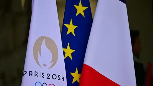 PARIS, FRANCE – JANUARY 18: The flag of the Paris 2024 Olympic Games is seen near the French national flag and the European flag at the entrance of the Elysee Palace during a welcome ceremony for Cambodia's Prime Minister ahead of a meeting at the Elysee on January 18, 2024 in Paris, France. Prime Minister Of Cambodia Hun Mane arrived at the Elysee Palace today to meet with President Macron of France.  (Photo by Christian Liewig – Corbis/Getty Images)
