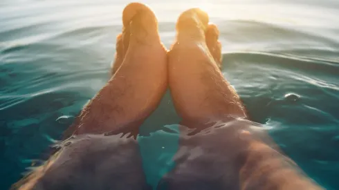 Male feet in outdoor swimming pool
