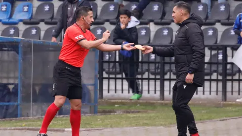 Felipe González entrega al cuarto árbitro sopaipilla que le llegó al arquero de Huachipato.
