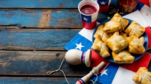 Chilean  independence  day  concept.  fiestas  patrias.  Chilean  typical  dish  and  drink  on  independence  day  party,  18  september.  Mini  empanadas,  mote  con  huesillo,  wine  with  toasted  flour,  chicha  and  tipical  play  emboque. xkwx chile,  chilean,  empanada,  independence,  flour,  food,  flag,  banner,  traditional,  national,  star,  country,  celebration,  18,  september,  holiday,  patriotic,  decoration,  patriotism,  text,  fun,  background,  fast,  hot,  popular,  snack,  american,  nation,  party,  patriot,  post,  santiago,  sign,  tradition,  independent,  wine,  harina  tostada,  chicha,  emboque,  mote,  huesillo,  empanadas,  husked,  wheat,  peach,  dried
