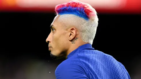 BARCELONA, SPAIN – MAY 20: Raphinha of FC Barcelona looks on, with a Blue and Red stripe in their hair, warms up prior to the LaLiga Santander match between FC Barcelona and Real Sociedad at Spotify Camp Nou on May 20, 2023 in Barcelona, Spain. (Photo by David Ramos/Getty Images)
