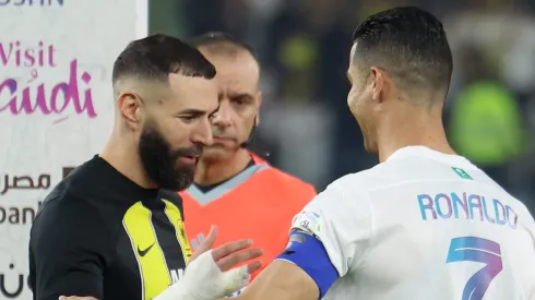  Karim Benzema of Al-Ittihad shakes hands with Cristiano Ronaldo of Al Nassr  (Photo by Yasser Bakhsh/Getty Images)
