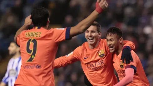Barcelona's Lionel Messi, center, celebrates after scoring against Deportivo with teammates Neymar, right, and Luis Suarez during a Spanish La Liga soccer match at the Riazor stadium in A Coruna, Spain, Sunday, Jan. 18, 2015. (AP Photo/Lalo R. Villar)